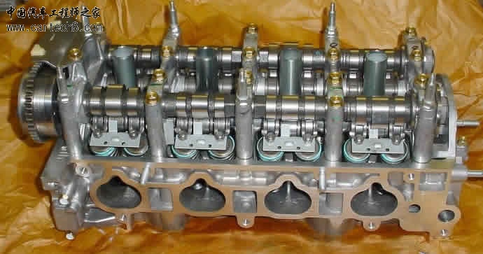 Image of a cylinder head from a Honda K20 showing components of the i-VTEC system.jpg